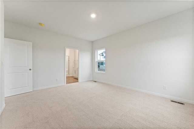 2114 Creek View Ln, Raymore, MO 64083 - unfurnished bedroom with light carpet, baseboards, and ensuite bathroom