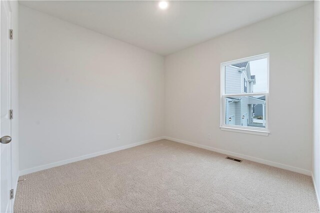2114 Creek View Ln, Raymore, MO 64083 - empty room featuring light carpet and baseboards