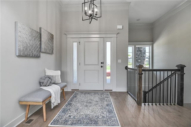 5854 Mccormick Dr, Shawnee, KS 66226 - entrance foyer featuring wood finished floors, a chandelier, crown molding, baseboards, and a high ceiling