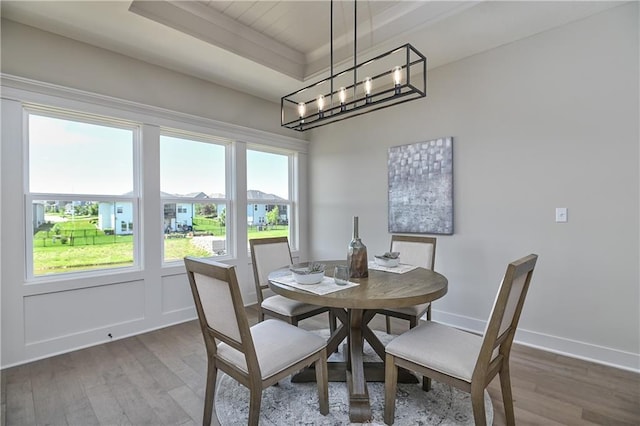 5854 Mccormick Dr, Shawnee, KS 66226 - dining area featuring wood finished floors, a tray ceiling, and baseboards