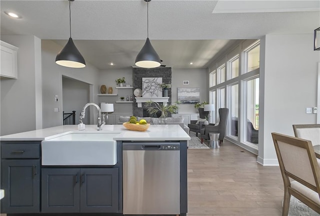 5854 Mccormick Dr, Shawnee, KS 66226 - kitchen with dishwasher, a sink, open floor plan, light countertops, and recessed lighting