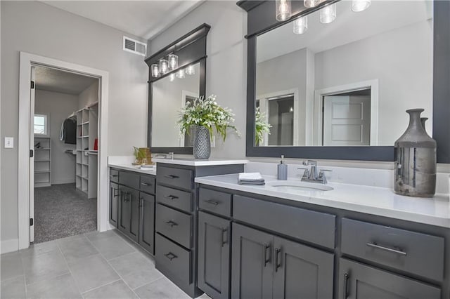 5854 Mccormick Dr, Shawnee, KS 66226 - full bathroom with double vanity, a walk in closet, and tile patterned flooring