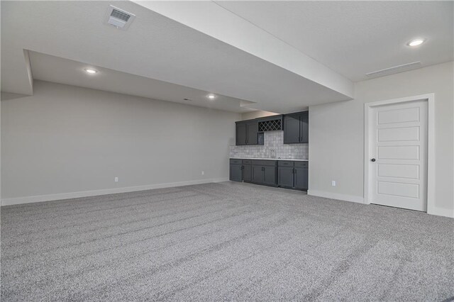 5854 Mccormick Dr, Shawnee, KS 66226 - unfurnished living room with bar area, light carpet, baseboards, and recessed lighting