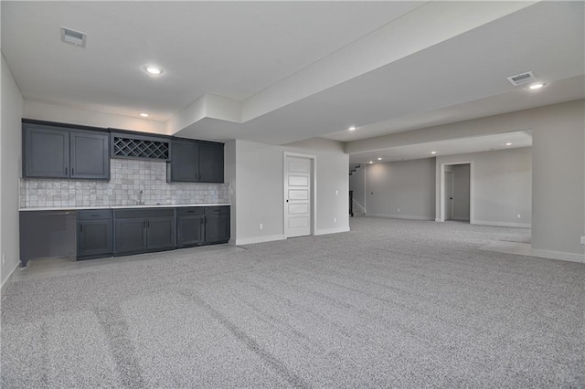 5854 Mccormick Dr, Shawnee, KS 66226 - unfurnished living room featuring bar with sink, baseboards, light colored carpet, and recessed lighting
