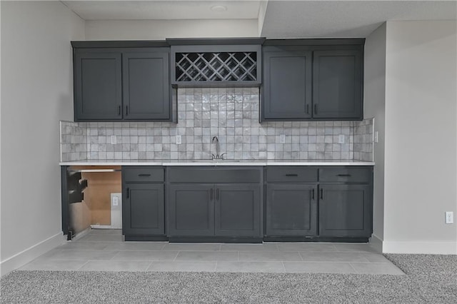 5854 Mccormick Dr, Shawnee, KS 66226 - kitchen featuring light countertops, gray cabinets, baseboards, and decorative backsplash
