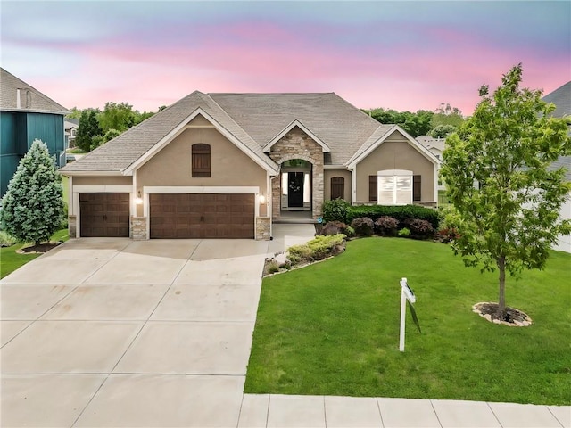 12750 N Arbor Way, Platte City, MO 64079 - view of front of property featuring stone siding, stucco siding, a front yard, concrete driveway, and an attached garage