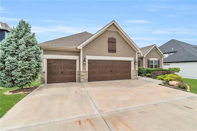 12750 N Arbor Way, Platte City, MO 64079 - view of front of property with stucco siding, an attached garage, concrete driveway, and stone siding