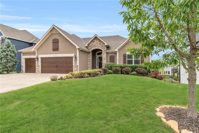 12750 N Arbor Way, Platte City, MO 64079 - view of front of home with stone siding, stucco siding, a front yard, an attached garage, and concrete driveway