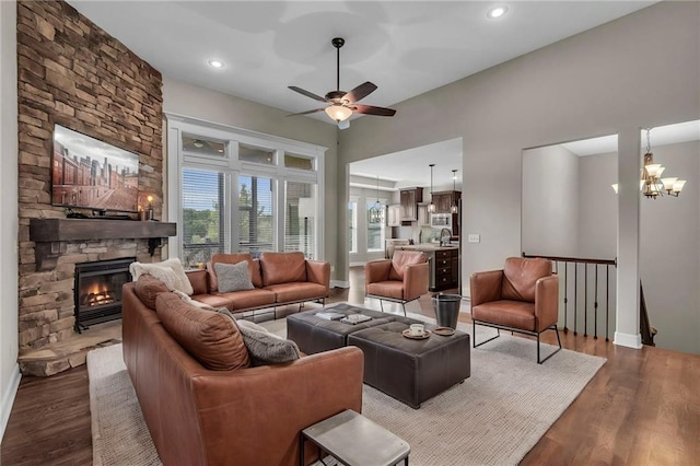12750 N Arbor Way, Platte City, MO 64079 - living room with wood finished floors, ceiling fan, baseboards, a stone fireplace, and recessed lighting