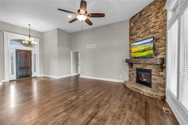12750 N Arbor Way, Platte City, MO 64079 - unfurnished living room featuring a fireplace, a chandelier, ceiling fan, dark wood-type flooring, and plenty of natural light