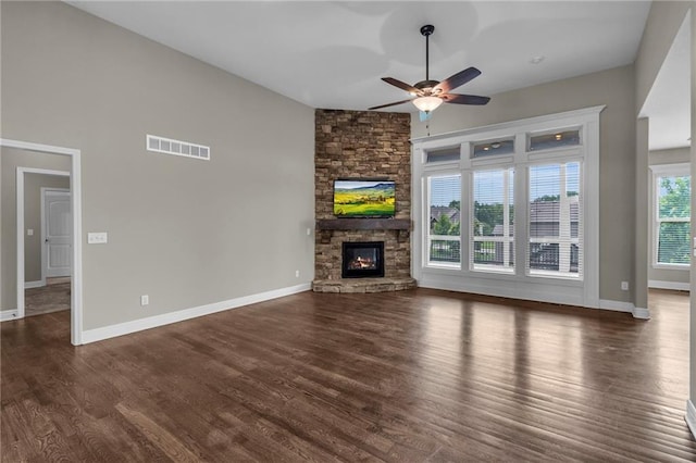 12750 N Arbor Way, Platte City, MO 64079 - unfurnished living room with ceiling fan, wood finished floors, a stone fireplace, baseboards, and lofted ceiling