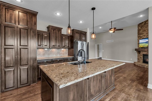 12750 N Arbor Way, Platte City, MO 64079 - kitchen with stainless steel refrigerator with ice dispenser, a sink, ceiling fan, decorative backsplash, and an island with sink