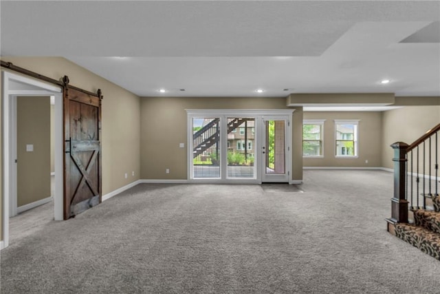12750 N Arbor Way, Platte City, MO 64079 - unfurnished living room with a barn door, carpet flooring, baseboards, recessed lighting, and stairs