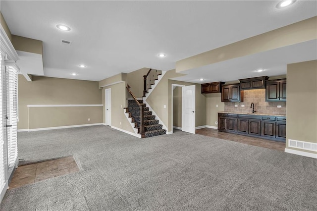 12750 N Arbor Way, Platte City, MO 64079 - unfurnished living room with carpet floors, a sink, stairway, recessed lighting, and baseboards