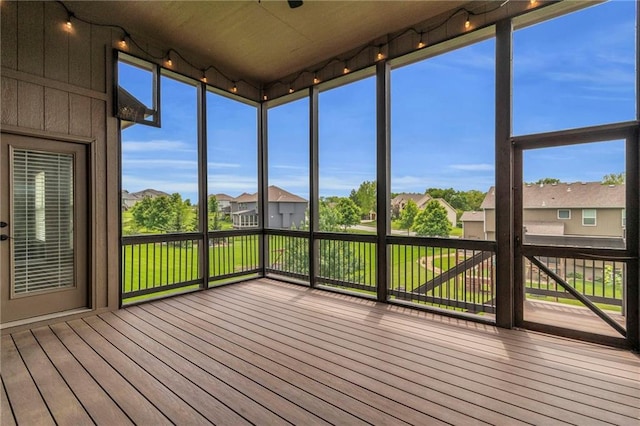 12750 N Arbor Way, Platte City, MO 64079 - unfurnished sunroom with a deck, a residential view, and hardwood / wood-style flooring