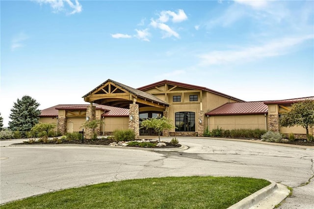 12750 N Arbor Way, Platte City, MO 64079 - craftsman-style home with stone siding, stucco siding, and curved driveway