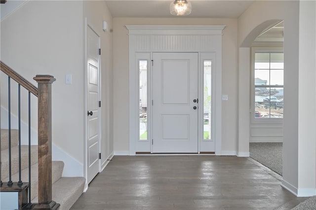 111 N Singletree St, Olathe, KS 66061 - foyer entrance featuring arched walkways, stairs, hardwood / wood-style flooring, and baseboards