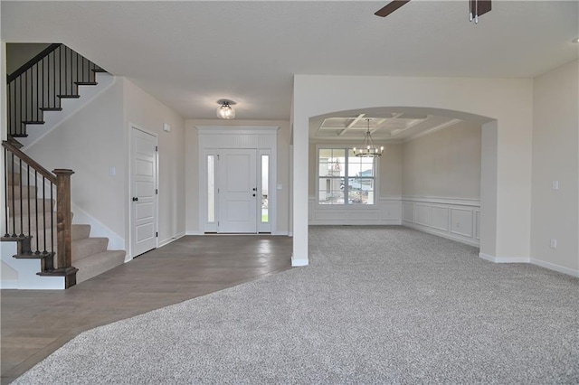 111 N Singletree St, Olathe, KS 66061 - carpeted entrance foyer with a chandelier, stairway, ceiling fan, arched walkways, and wainscoting
