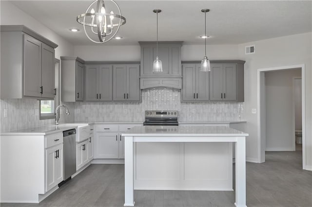 111 N Singletree St, Olathe, KS 66061 - kitchen featuring appliances with stainless steel finishes, gray cabinetry, light countertops, wood finished floors, and recessed lighting