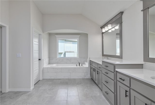111 N Singletree St, Olathe, KS 66061 - bathroom with vanity, a garden tub, lofted ceiling, and tile patterned floors
