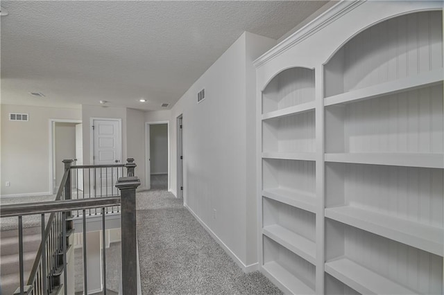 111 N Singletree St, Olathe, KS 66061 - hall featuring carpet floors, a textured ceiling, baseboards, and built in shelves