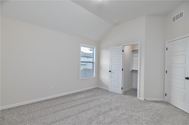 111 N Singletree St, Olathe, KS 66061 - unfurnished bedroom featuring light carpet, lofted ceiling, a spacious closet, and baseboards