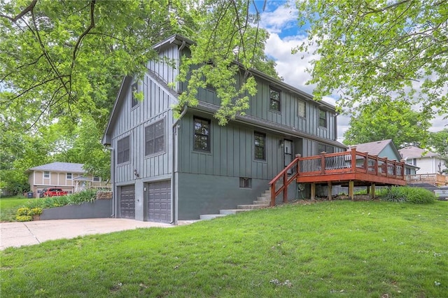 313 SW Ensley Ln, Lees Summit, MO 64081 - rear view of house featuring board and batten siding, an attached garage, stairs, and a yard