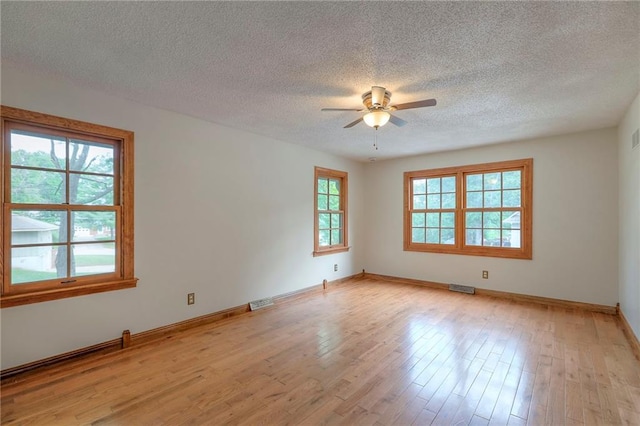 313 SW Ensley Ln, Lees Summit, MO 64081 - empty room featuring a ceiling fan, a textured ceiling, light wood finished floors, and baseboards