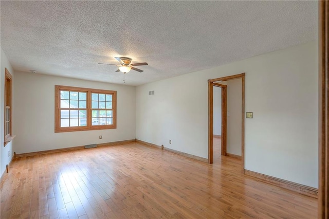313 SW Ensley Ln, Lees Summit, MO 64081 - empty room with a ceiling fan, a textured ceiling, light wood finished floors, and baseboards