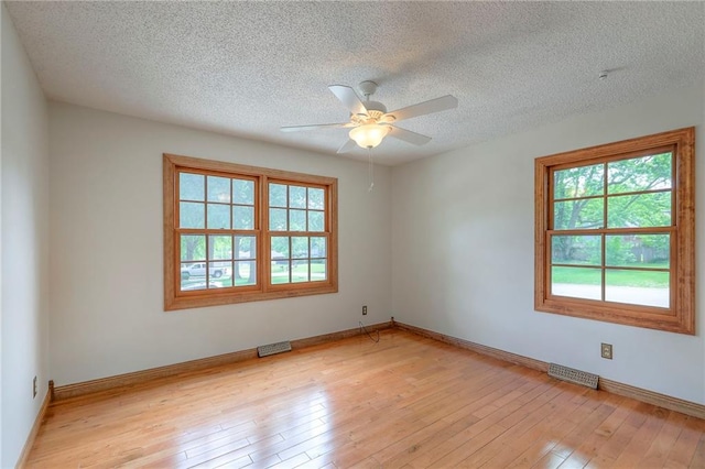 313 SW Ensley Ln, Lees Summit, MO 64081 - empty room with light wood-type flooring, a ceiling fan, a textured ceiling, and baseboards