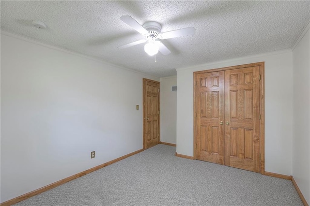 313 SW Ensley Ln, Lees Summit, MO 64081 - unfurnished bedroom featuring carpet, a textured ceiling, a closet, ceiling fan, and baseboards