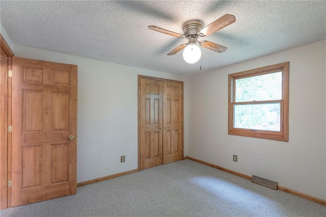 313 SW Ensley Ln, Lees Summit, MO 64081 - unfurnished bedroom with carpet floors, baseboards, a textured ceiling, and a closet