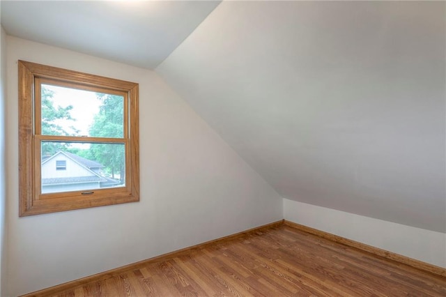 313 SW Ensley Ln, Lees Summit, MO 64081 - bonus room featuring vaulted ceiling, light wood finished floors, and baseboards
