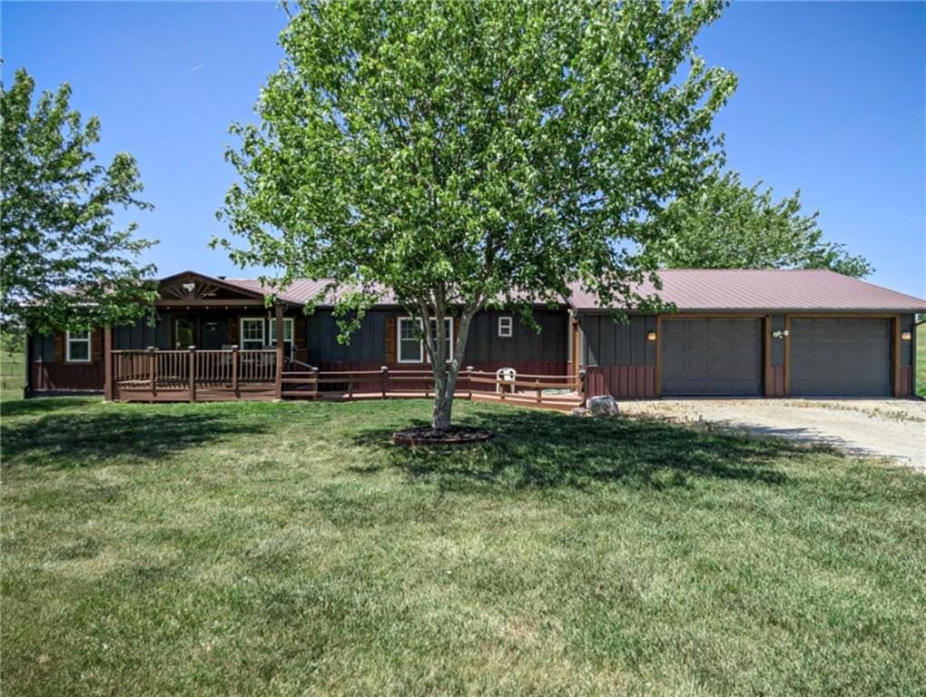 7380 County Road 64th Rd, Savannah, MO 64485 - ranch-style house featuring a front lawn, dirt driveway, metal roof, and a wooden deck