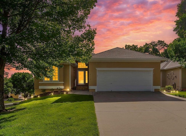 ranch-style house with stucco siding, concrete driveway, a garage, and a front lawn