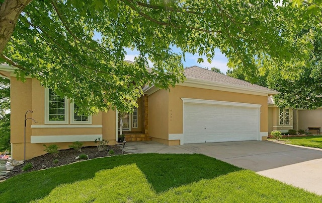 view of front facade with a front yard, an attached garage, stucco siding, and concrete driveway