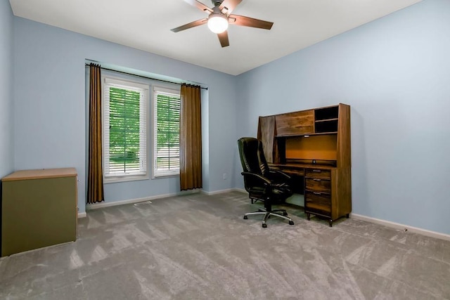 office area featuring carpet flooring, baseboards, and a ceiling fan