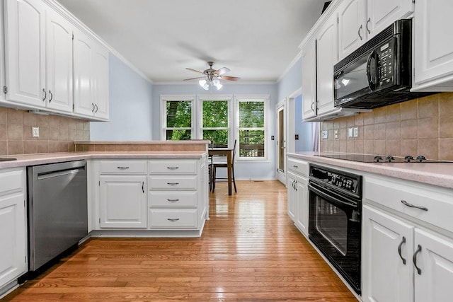 kitchen featuring black appliances, crown molding, ceiling fan, light countertops, and light wood-type flooring