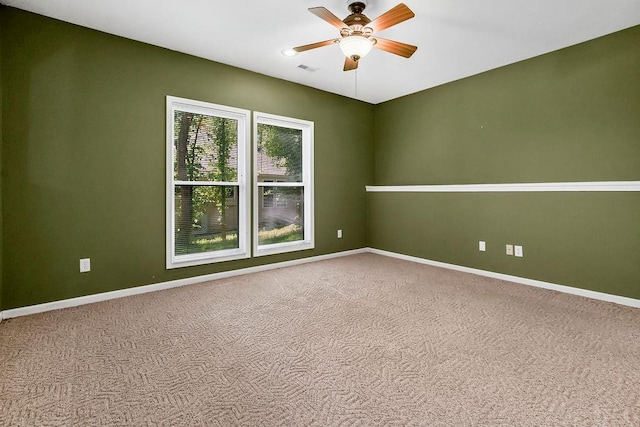 spare room featuring a ceiling fan, baseboards, and carpet floors