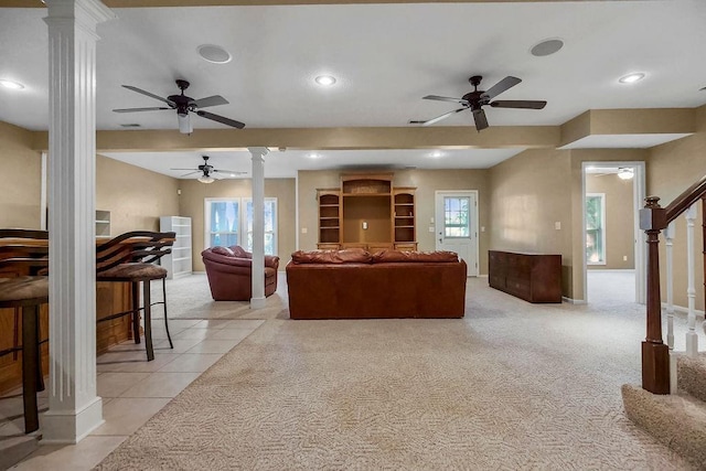 living area with decorative columns, ceiling fan, stairs, recessed lighting, and light tile patterned floors