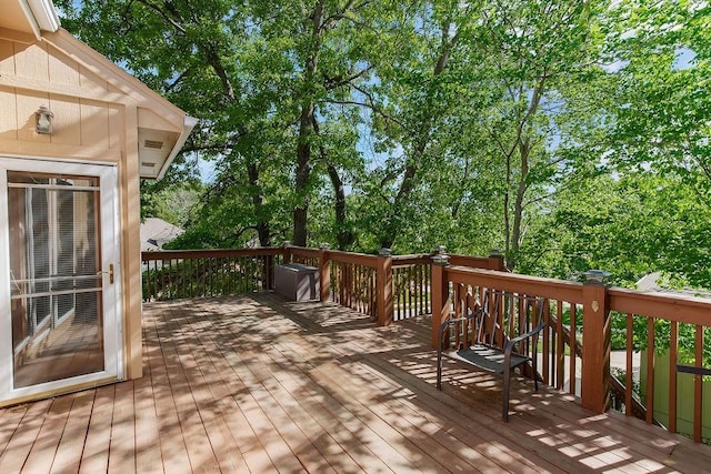 deck featuring view of wooded area