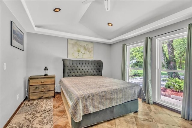 bedroom with a tray ceiling and recessed lighting
