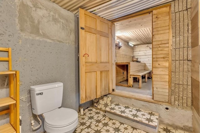 bathroom with toilet and tile patterned floors