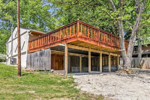 back of house with a deck and central AC