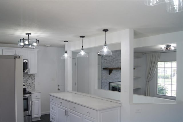 1919 Seneca St, Leavenworth, KS 66048 - kitchen featuring stainless steel appliances, white cabinetry, tasteful backsplash, and light countertops