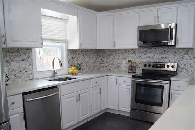 1919 Seneca St, Leavenworth, KS 66048 - kitchen with appliances with stainless steel finishes, a sink, white cabinets, and tasteful backsplash
