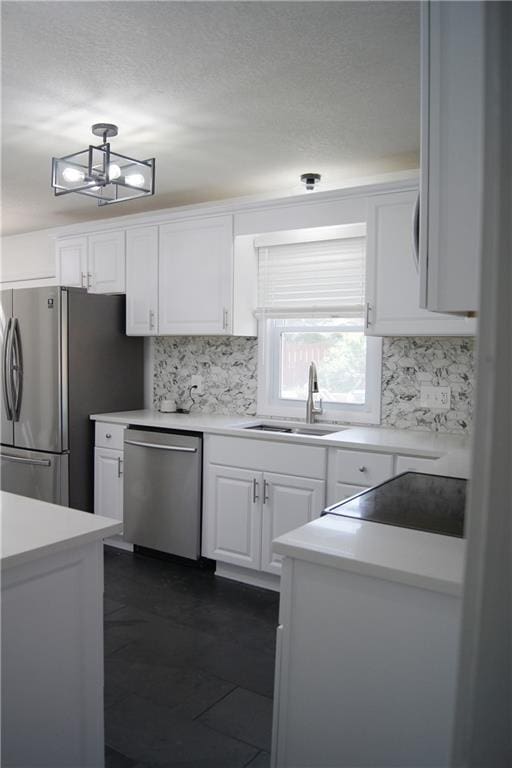 1919 Seneca St, Leavenworth, KS 66048 - kitchen featuring stainless steel appliances, tasteful backsplash, white cabinets, and a sink