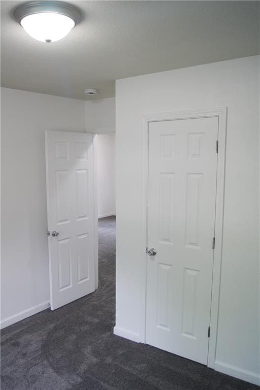 1919 Seneca St, Leavenworth, KS 66048 - spare room featuring dark carpet and baseboards
