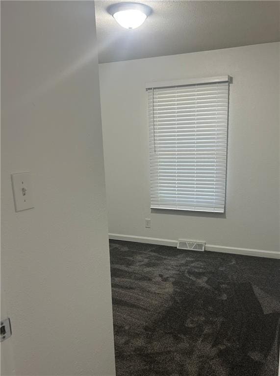 1919 Seneca St, Leavenworth, KS 66048 - unfurnished room with dark carpet and baseboards