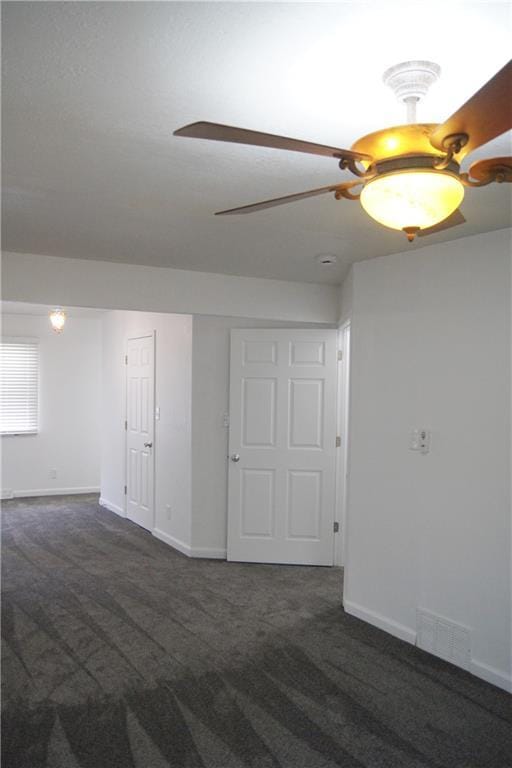 1919 Seneca St, Leavenworth, KS 66048 - carpeted spare room with baseboards and a ceiling fan